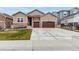 Inviting home exterior with a two-car garage, well-kept lawn, and classic architectural details at 5839 Hay Market Trl, Parker, CO 80134