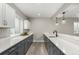 Bright kitchen features long white countertops, gray cabinets and stainless steel appliances at 5839 Hay Market Trl, Parker, CO 80134