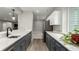 Galley kitchen with sleek, white countertops and gray cabinetry providing ample storage at 5839 Hay Market Trl, Parker, CO 80134