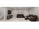 Finished basement with leather sofa and entertainment center by the staircase and window at 5839 Hay Market Trl, Parker, CO 80134