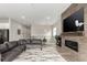 Cozy living room with a modern fireplace, large TV, comfortable seating, and stylish decor at 5839 Hay Market Trl, Parker, CO 80134