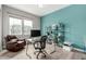 Bright home office with a teal accent wall, modern desk, shelving, and comfortable leather chair at 5839 Hay Market Trl, Parker, CO 80134