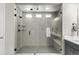 Walk-in shower with a glass door, rain shower head, and built-in shelving at 5839 Hay Market Trl, Parker, CO 80134