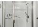 Bright and modern bathroom shower features white tiled walls, glass door, and updated fixtures at 5839 Hay Market Trl, Parker, CO 80134