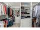 Spacious walk-in closet with custom shelving and ample storage for clothes, handbags and accessories at 5839 Hay Market Trl, Parker, CO 80134