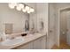 Bright bathroom boasts a double sink vanity, updated lighting, and modern fixtures at 8500 E Jefferson Ave # 11C, Denver, CO 80237