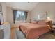 Comfortable bedroom features a cozy bed, soft lighting, and a large window offering natural light and peaceful views at 8500 E Jefferson Ave # 11C, Denver, CO 80237