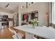 Bright dining space seamlessly flows into the kitchen, enhanced by sleek lighting and providing a comfortable atmosphere at 8500 E Jefferson Ave # 11C, Denver, CO 80237