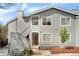 Modern condo building with light gray siding, a striking entrance, and well-maintained landscaping at 8500 E Jefferson Ave # 11C, Denver, CO 80237
