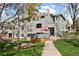 Beautifully landscaped condo exterior with mature trees and inviting walkways on a sunny day at 8500 E Jefferson Ave # 11C, Denver, CO 80237