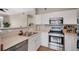 Well-lit kitchen featuring stainless steel appliances, white cabinets, and modern fixtures for a stylish cooking space at 8500 E Jefferson Ave # 11C, Denver, CO 80237