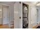 Convenient in-unit laundry closet featuring a stacked washer and dryer at 8500 E Jefferson Ave # 11C, Denver, CO 80237
