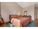 Bright bedroom featuring wood floors, vaulted ceiling, and warm natural light at 8500 E Jefferson Ave # 11C, Denver, CO 80237