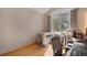 Bright office with large window, hardwood floors, and a dog kennel at 8500 E Jefferson Ave # 11C, Denver, CO 80237