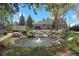 Relaxing community pond with fountain, lush greenery, and nearby condos at 8500 E Jefferson Ave # 11C, Denver, CO 80237