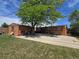 Expansive backyard featuring detached garage, large patio, and mature shade tree, perfect for outdoor entertaining at 7371 Granada Rd, Denver, CO 80221