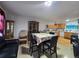 Open-concept living area with kitchen access, tile floors, and comfortable seating at 7371 Granada Rd, Denver, CO 80221