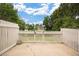 Backyard with a well-kept lawn and white picket fence providing a private and secure outdoor living space at 2856 S Kenton Ct, Aurora, CO 80014