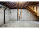 An unfinished basement with open ceiling joists and concrete floors, ready to be renovated and personalized at 2856 S Kenton Ct, Aurora, CO 80014