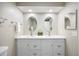 Bright bathroom featuring a double sink vanity with modern fixtures and decorative mirrors at 2856 S Kenton Ct, Aurora, CO 80014