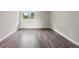 A spacious bedroom with modern wood-look floors and natural light creating a bright and airy atmosphere at 2856 S Kenton Ct, Aurora, CO 80014