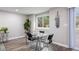 Modern dining area with a glass table, seating for four, and view of the backyard at 2856 S Kenton Ct, Aurora, CO 80014