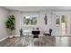 Modern dining area with a glass table, seating for four, and view of the backyard at 2856 S Kenton Ct, Aurora, CO 80014