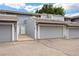 Exterior view of the townhome with gray siding, attached garages, and well-maintained landscaping at 2856 S Kenton Ct, Aurora, CO 80014