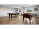 Spacious game room with pool table, foosball table, and modern lighting, perfect for entertaining at 2856 S Kenton Ct, Aurora, CO 80014