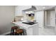 Well-equipped kitchen featuring modern appliances, marble counters, and breakfast bar at 2856 S Kenton Ct, Aurora, CO 80014