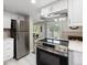 Modern kitchen with stainless steel appliances and a view of the fireplace at 2856 S Kenton Ct, Aurora, CO 80014