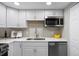 Updated kitchen showcasing white cabinets, stainless steel appliances, countertop, and ample storage at 2856 S Kenton Ct, Aurora, CO 80014