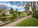 A lovely pond is surrounded by lush greenery and a walking path, perfect for peaceful strolls at 2856 S Kenton Ct, Aurora, CO 80014