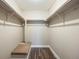Bright walk-in closet with modern wood-look floors and built in shelving for optimal storage and organization at 2856 S Kenton Ct, Aurora, CO 80014