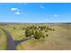 Stunning aerial view of a home with mature trees and a long driveway, set on vast acreage at 7645 Fox Creek Trl, Franktown, CO 80116