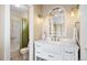Bathroom featuring shower and bath with white vanity and vintage mirror at 7645 Fox Creek Trl, Franktown, CO 80116