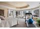 Bright bedroom featuring large windows with natural light, exercise equipment, and a king bed at 7645 Fox Creek Trl, Franktown, CO 80116