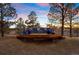 Exterior deck area with a plush sectional sofa and colorful accent pillows at 7645 Fox Creek Trl, Franktown, CO 80116