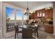Cozy dining area with backyard patio access and built in wood cabinets at 7645 Fox Creek Trl, Franktown, CO 80116