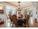 Elegant dining room with hardwood floors, ornate chandelier, and bay window at 7645 Fox Creek Trl, Franktown, CO 80116