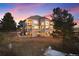Exterior elevation of a home featuring multiple stories, balconies, large windows, and a spacious yard at 7645 Fox Creek Trl, Franktown, CO 80116