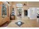 Inviting foyer with closet, piano, and transom windows above the front door at 7645 Fox Creek Trl, Franktown, CO 80116