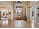 Grand foyer with high ceilings, decorative tile, and transom windows above the door at 7645 Fox Creek Trl, Franktown, CO 80116
