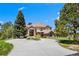 Elegant two-story home boasts a circular driveway, lush landscaping, and a welcoming entrance at 7645 Fox Creek Trl, Franktown, CO 80116