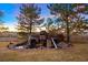 Front yard featuring a vintage truck as a water feature with a rock surround and landscaping at 7645 Fox Creek Trl, Franktown, CO 80116