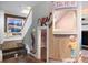 Hallway with playful murals, staircase, and cozy reading nook under a bright window at 7645 Fox Creek Trl, Franktown, CO 80116