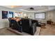 Home theater features comfortable seating, projector, and a wet bar for entertaining at 7645 Fox Creek Trl, Franktown, CO 80116