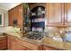 Gourmet kitchen details include cooktop, custom spice shelves and granite counters at 7645 Fox Creek Trl, Franktown, CO 80116