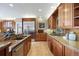 Well-appointed kitchen with wood cabinetry, granite countertops, and stainless steel appliances at 7645 Fox Creek Trl, Franktown, CO 80116