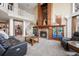 Spacious living room boasts a grand fireplace and open floor plan at 7645 Fox Creek Trl, Franktown, CO 80116